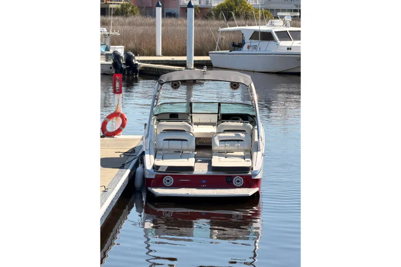 Slide: The Image of 2019 Regal LS4 boat docked at marina, featuring sleek design and comfortable seating. - 4