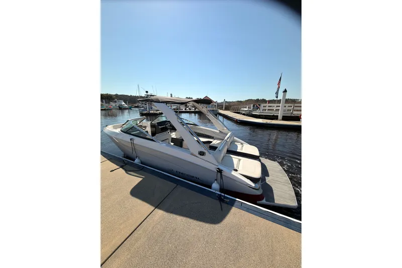Slide: The Image of 2019 Regal LS4 boat docked at a marina under clear blue skies. - 5