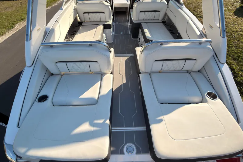 Slide: The Image of 2019 Regal LS4 boat interior with luxurious white seating and cup holders. - 9