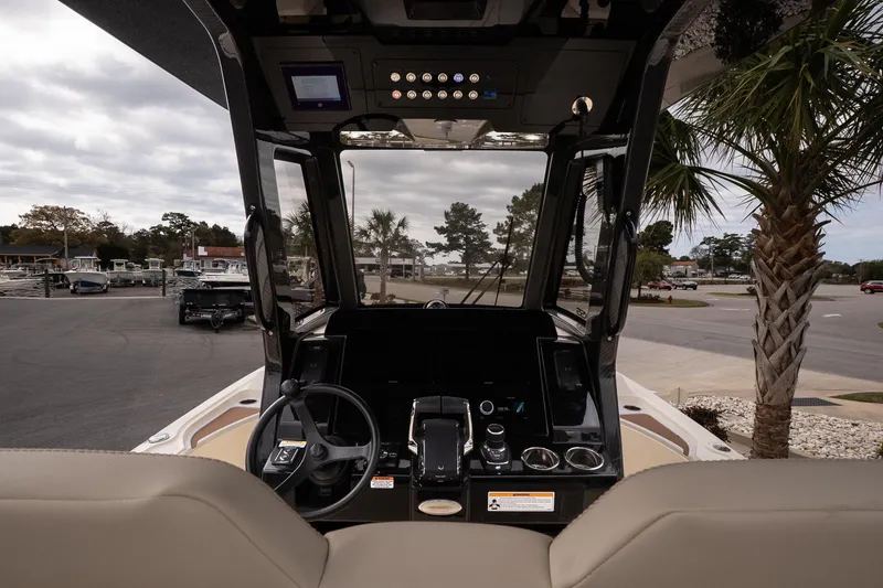 Slide: The Image of Interior view of 2026 Scout 281 XSS boat cockpit with steering wheel and controls. - 10