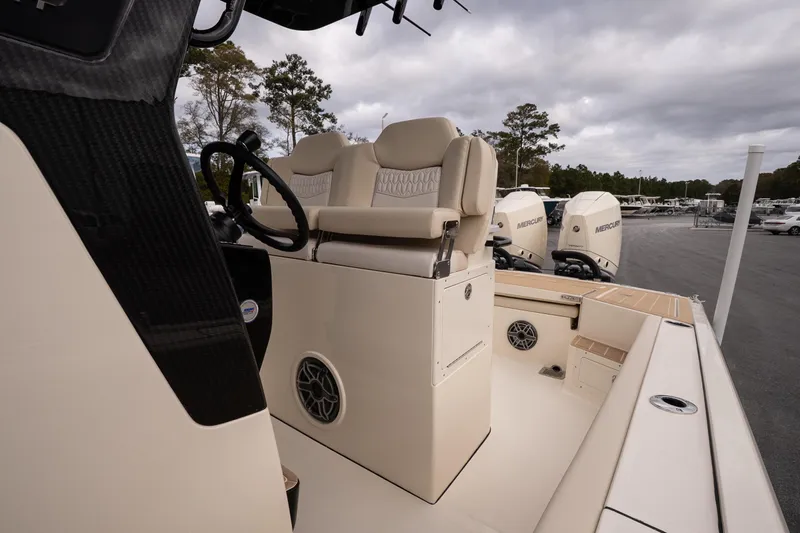 Slide: The Image of 2026 Scout 281 XSS boat interior with helm seat and Mercury engines. - 11