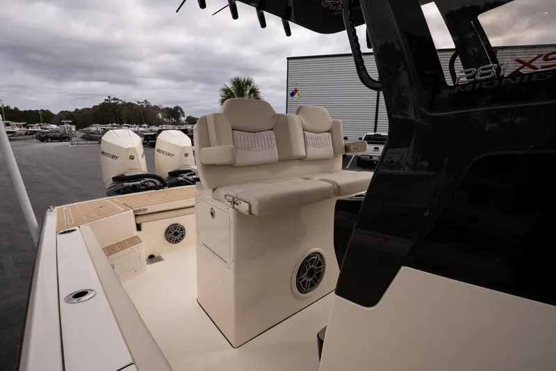 Slide: The Image of 2026 Scout 281 XSS boat interior with seating and Mercury engines in a marina setting. - 12