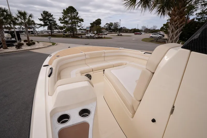Slide: The Image of 2026 Scout 281 XSS boat interior with beige seating and cup holders. - 14