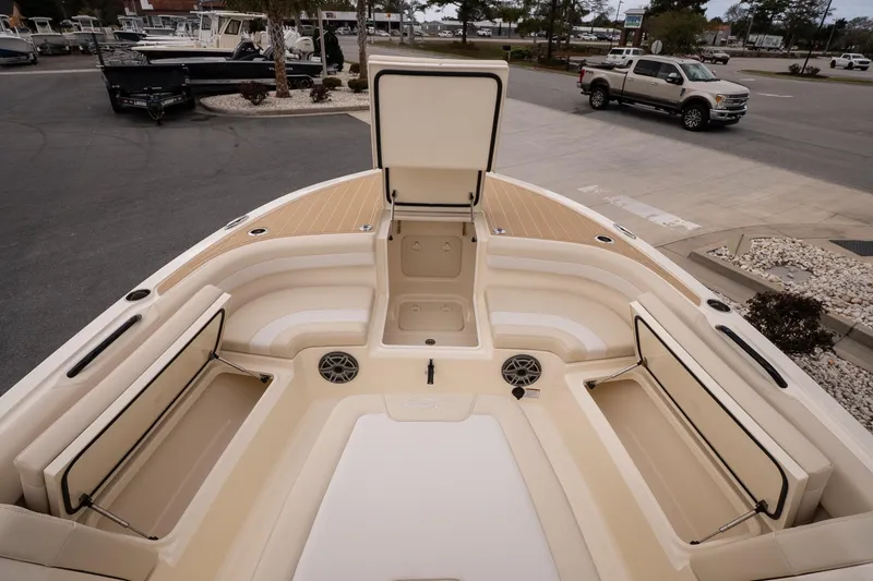 Slide: The Image of 2026 Scout 281 XSS boat interior with open storage compartments and seating area. - 16