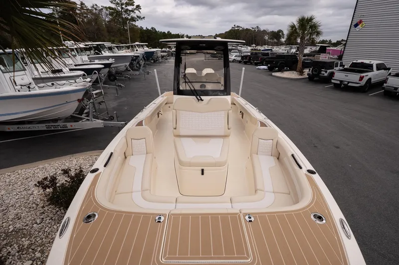 Slide: The Image of 2026 Scout 281 XSS boat with spacious seating, parked in a marina. - 17