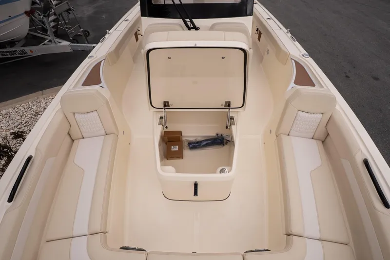 Slide: The Image of 2026 Scout 281 XSS boat interior with open storage compartment and seating. - 19