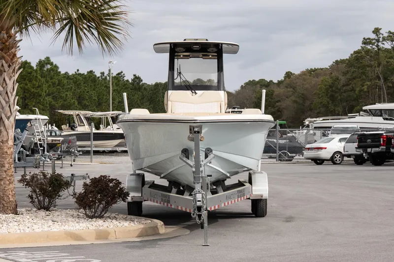 Slide: The Image of 2026 Scout 281 XSS boat on trailer in marina parking lot. - 2