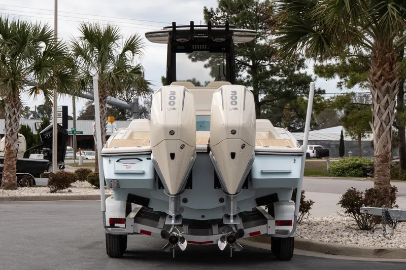 Slide: The Image of 2026 Scout 281 XSS boat with dual outboard engines on a trailer. - 4