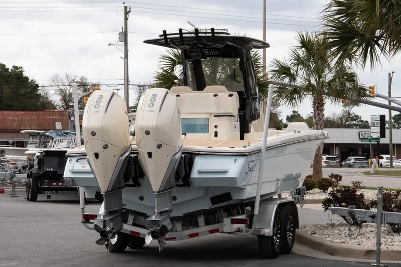 Slide: The Image of 2026 Scout 281 XSS boat with dual outboard engines on a trailer. - 5
