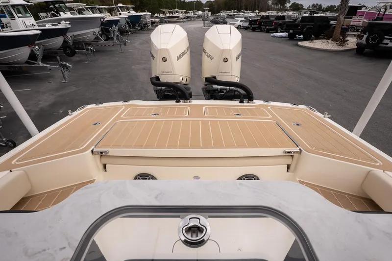 Slide: The Image of 2026 Scout 281 XSS boat with dual Mercury engines in a marina setting. - 7