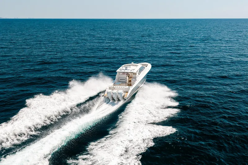 Slide: The Image of 2022 Pursuit DC 365 Dual Console boat cruising on open ocean waters. - 12