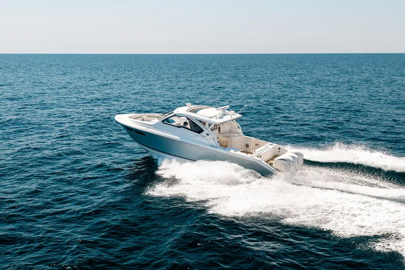 Slide: The Image of 2022 Pursuit DC 365 Dual Console boat cruising on open ocean waters. - 15