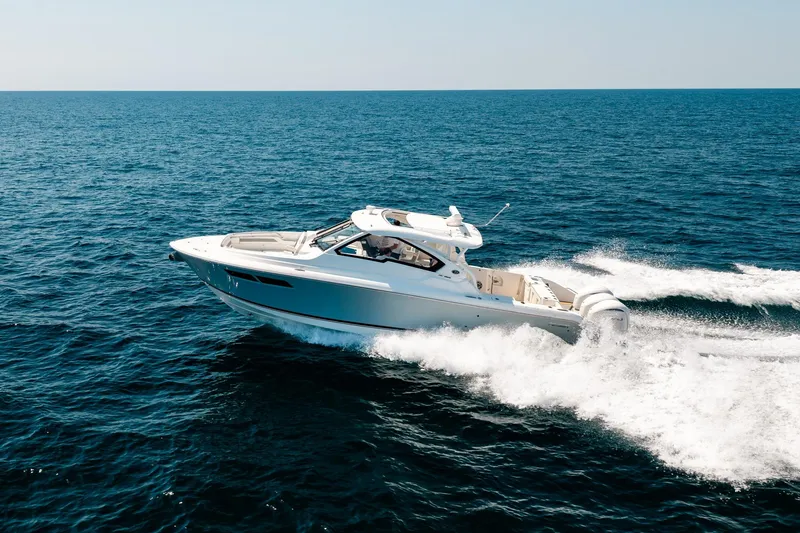 Slide: The Image of 2022 Pursuit DC 365 Dual Console boat cruising on open ocean waters. - 16