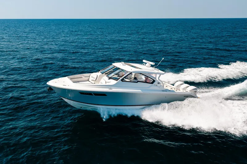 Slide: The Image of 2022 Pursuit DC 365 Dual Console boat cruising on open ocean waters. - 17