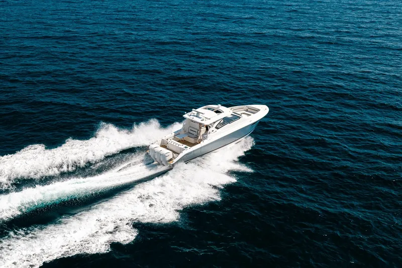 Slide: The Image of 2022 Pursuit DC 365 Dual Console cruising on open ocean waters. - 18