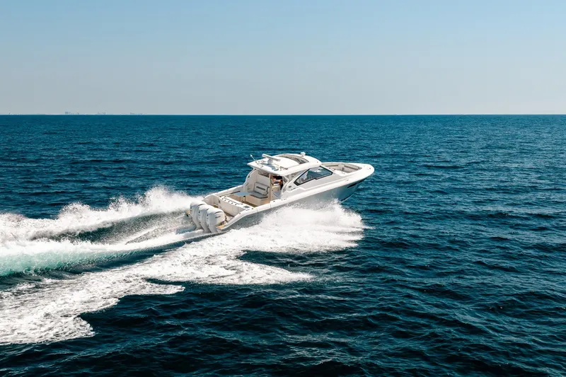 Slide: The Image of 2022 Pursuit DC 365 Dual Console cruising on open ocean waters. - 19