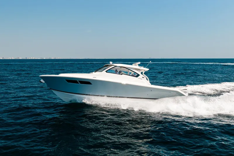 Slide: The Image of 2022 Pursuit DC 365 Dual Console boat cruising on open water. - 24