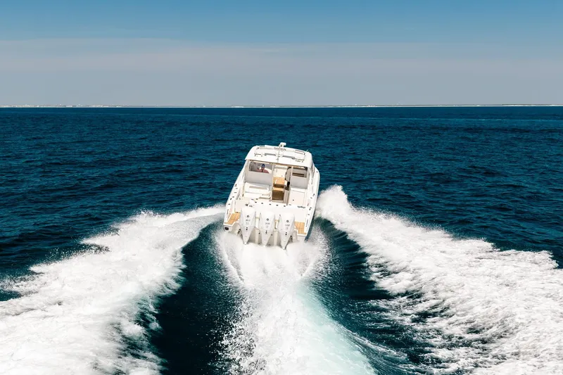 Slide: The Image of 2022 Pursuit DC 365 Dual Console cruising on open ocean waters. - 25