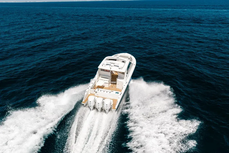Slide: The Image of 2022 Pursuit DC 365 Dual Console boat cruising on open ocean waters. - 26
