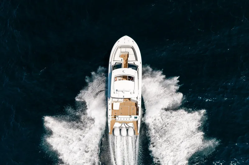 Slide: The Image of Aerial view of 2022 Pursuit DC 365 Dual Console boat cruising on open water. - 27