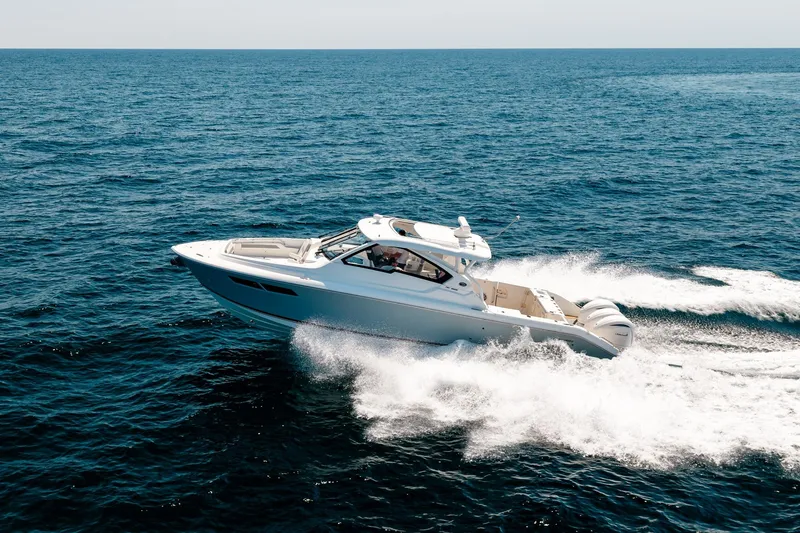 Slide: The Image of 2022 Pursuit DC 365 Dual Console boat cruising on open ocean waters. - 28