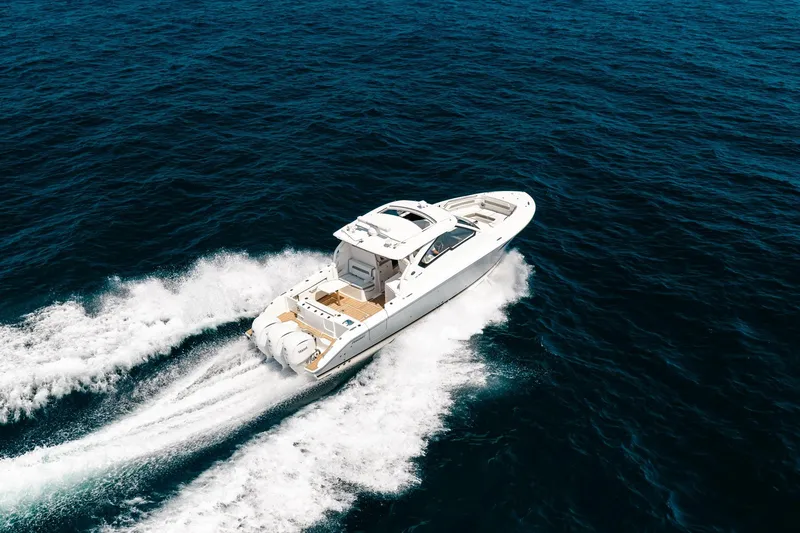 Slide: The Image of 2022 Pursuit DC 365 Dual Console cruising on open ocean waters. - 29