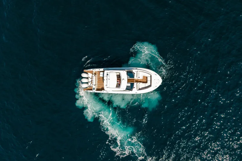 Slide: The Image of Aerial view of 2022 Pursuit DC 365 Dual Console boat cruising on open water. - 3