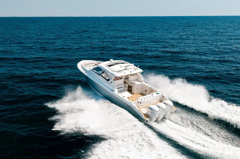 Slide: The Image of 2022 Pursuit DC 365 Dual Console boat cruising on open ocean waters. - 30