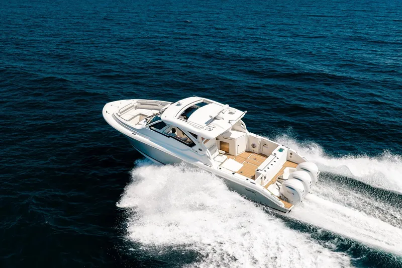 Slide: The Image of 2022 Pursuit DC 365 Dual Console boat cruising on open ocean waters. - 31