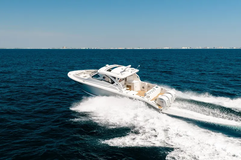 Slide: The Image of 2022 Pursuit DC 365 Dual Console boat cruising on open ocean waters. - 32