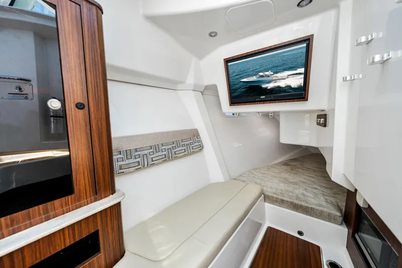 Slide: The Image of Luxurious interior of 2022 Pursuit DC 365 Dual Console boat with wood accents and seating. - 37