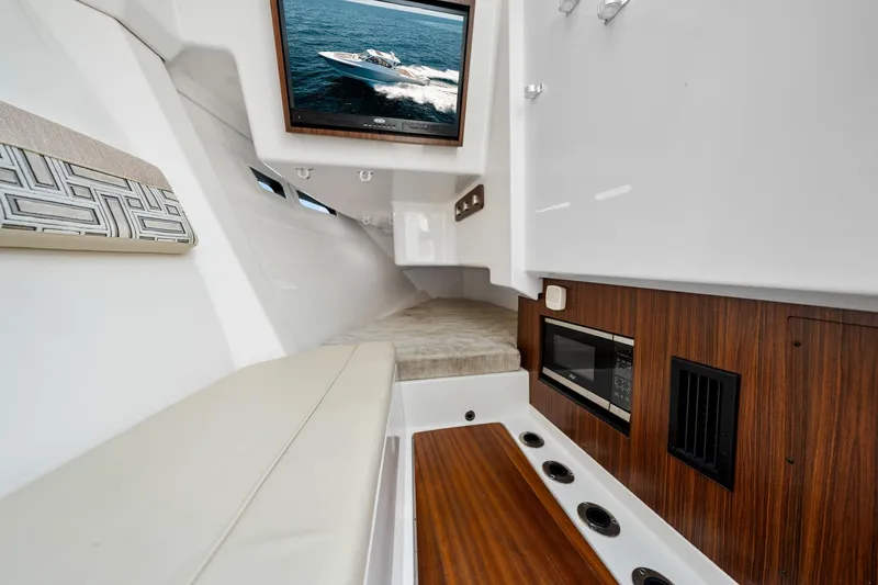 Slide: The Image of Interior of 2022 Pursuit DC 365 Dual Console with modern amenities and sleek design. - 38