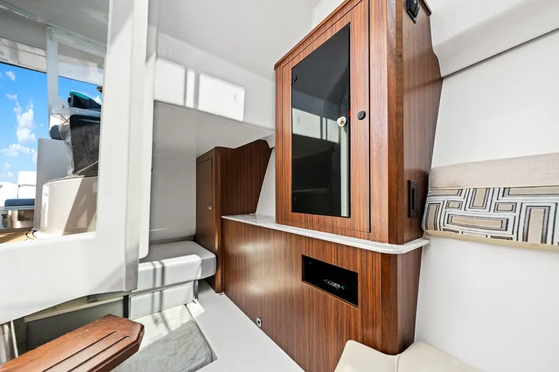 Slide: The Image of 2022 Pursuit DC 365 Dual Console interior with wooden cabinetry and seating. - 40