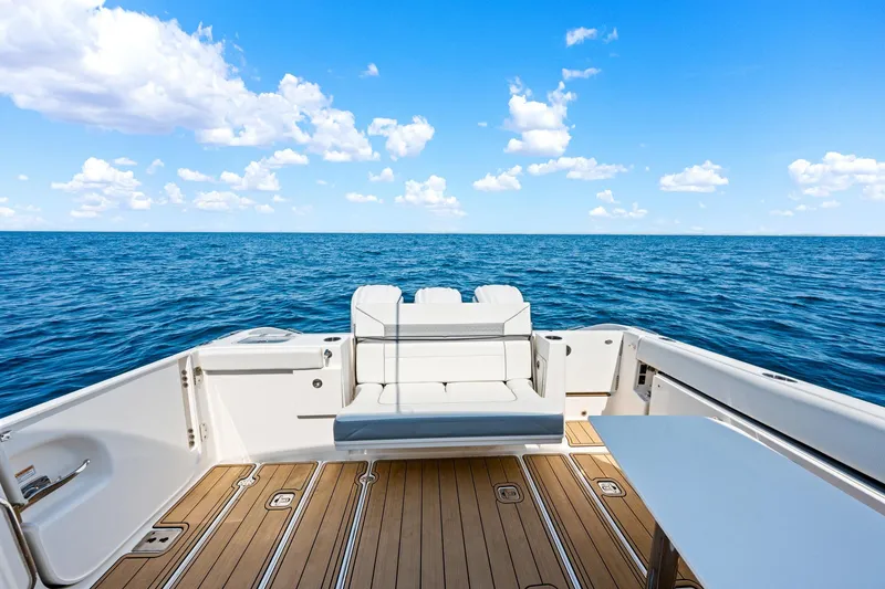 Slide: The Image of 2022 Pursuit DC 365 Dual Console boat with ocean view and seating area. - 41