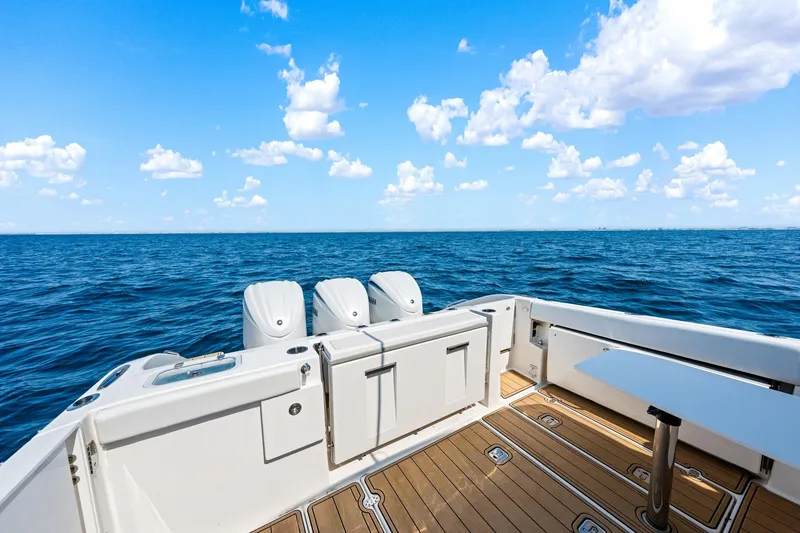 Slide: The Image of 2022 Pursuit DC 365 Dual Console boat on open sea under blue sky. - 44