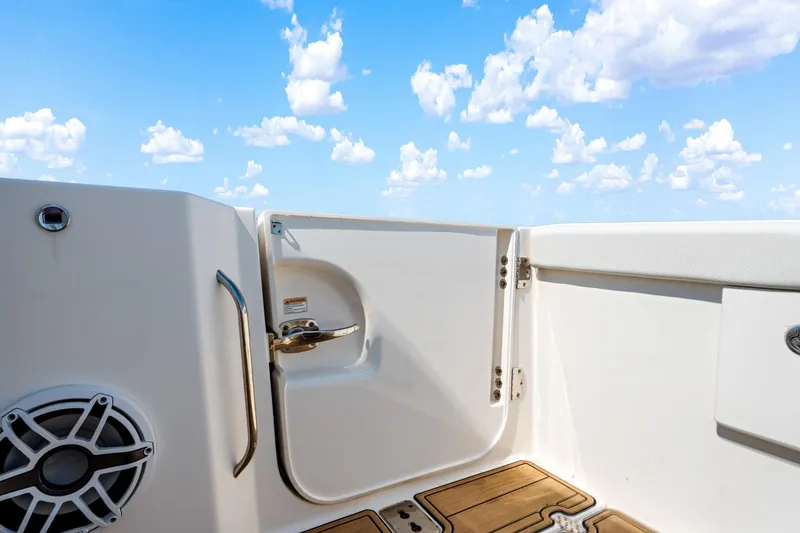 Slide: The Image of 2022 Pursuit DC 365 Dual Console boat deck with open door and blue sky. - 45