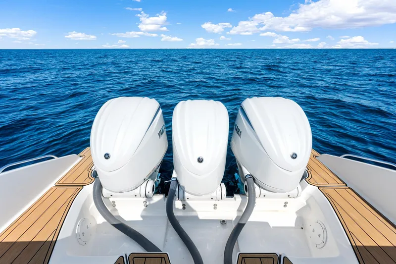 Slide: The Image of 2022 Pursuit DC 365 Dual Console with triple Yamaha outboard engines on open sea. - 46
