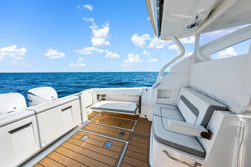 Slide: The Image of 2022 Pursuit DC 365 Dual Console boat interior with ocean view and seating area. - 49