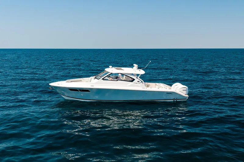 Slide: The Image of 2022 Pursuit DC 365 Dual Console boat cruising on open ocean waters. - 5