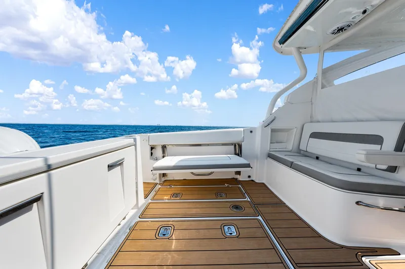Slide: The Image of 2022 Pursuit DC 365 Dual Console boat interior with ocean view and teak flooring. - 50