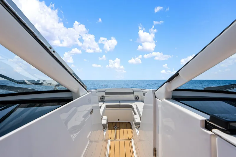 Slide: The Image of 2022 Pursuit DC 365 Dual Console boat interior with ocean view and clear sky. - 51