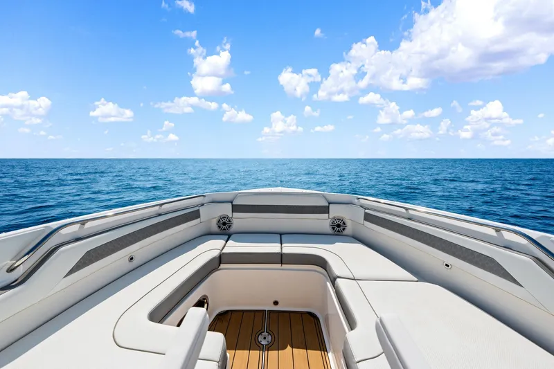 Slide: The Image of 2022 Pursuit DC 365 Dual Console boat on open sea under blue sky. - 52