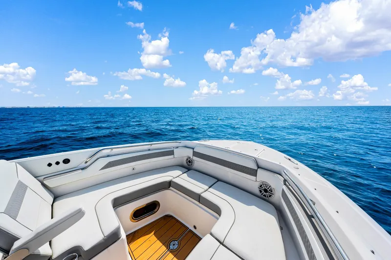 Slide: The Image of 2022 Pursuit DC 365 Dual Console boat on open ocean under blue sky. - 54