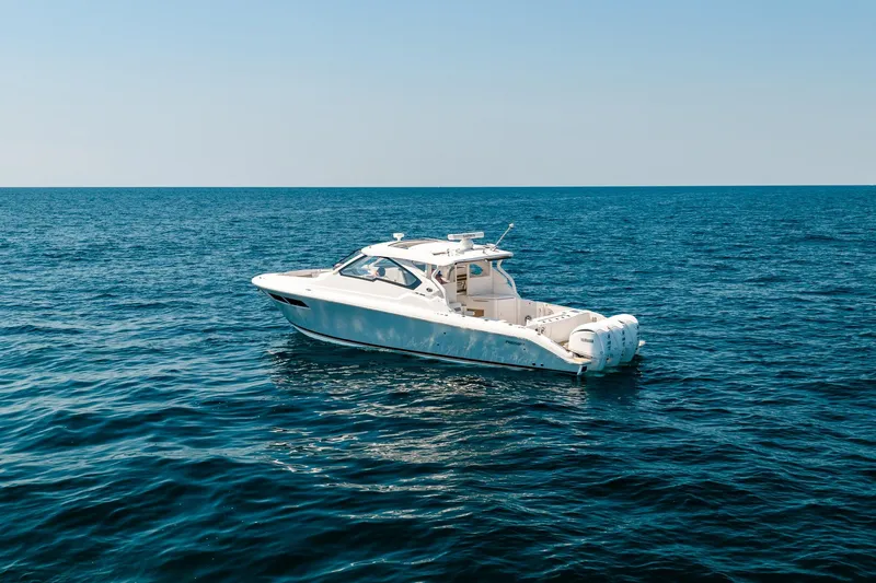 Slide: The Image of 2022 Pursuit DC 365 Dual Console boat on open sea under clear sky. - 6