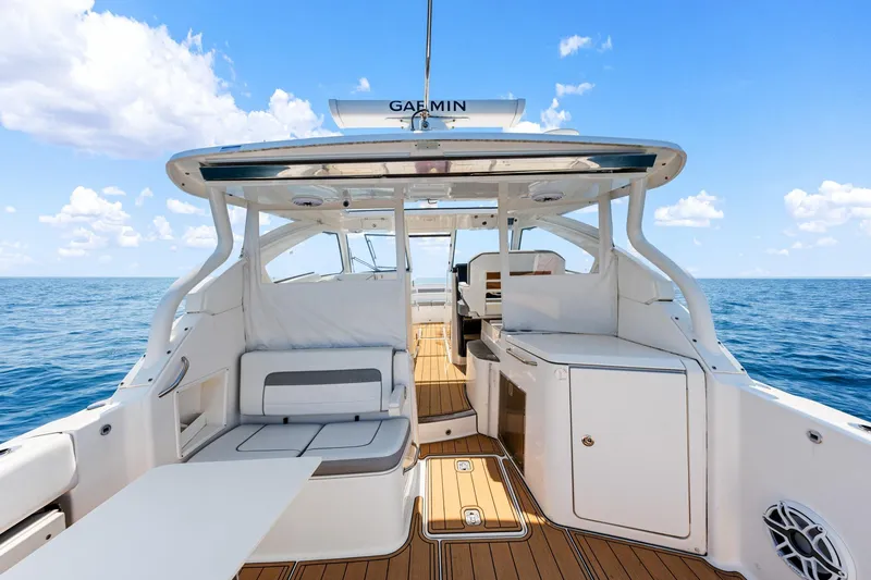 Slide: The Image of 2022 Pursuit DC 365 Dual Console boat interior with seating, ocean view, and clear sky. - 62