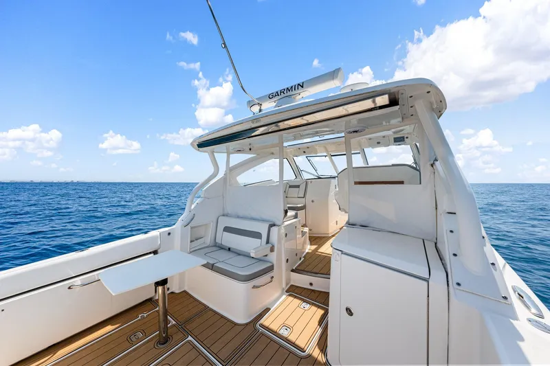 Slide: The Image of 2022 Pursuit DC 365 Dual Console boat interior on open sea under blue sky. - 63