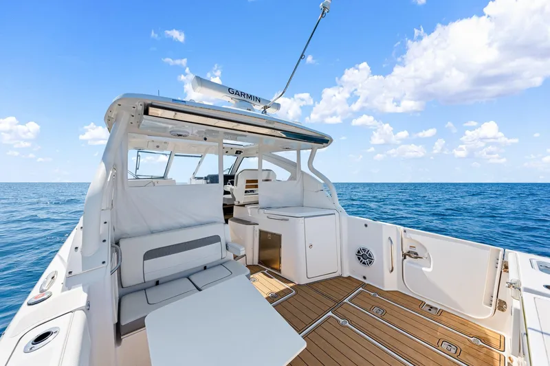 Slide: The Image of 2022 Pursuit DC 365 Dual Console boat on open sea under blue sky. - 64