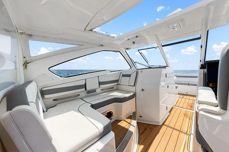 Slide: The Image of 2022 Pursuit DC 365 Dual Console interior with luxurious seating and ocean view. - 65