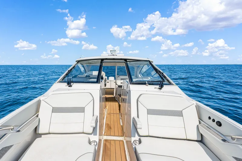 Slide: The Image of 2022 Pursuit DC 365 Dual Console boat on open sea under blue sky. - 67