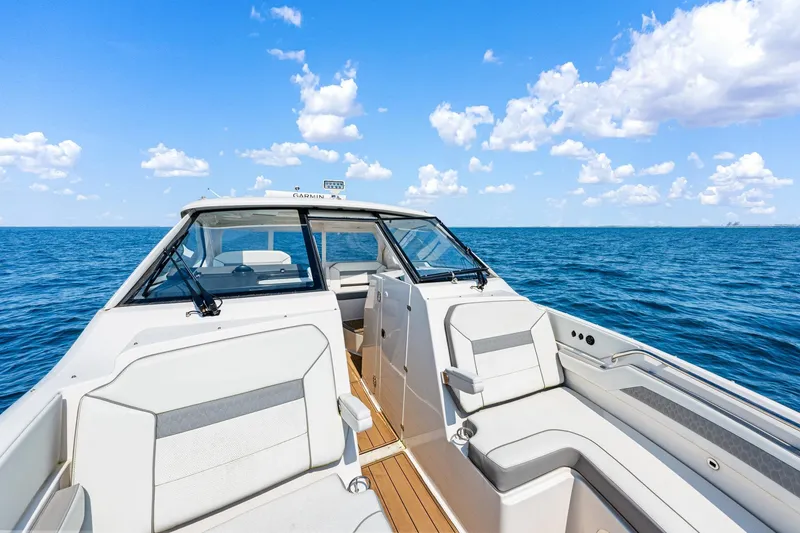 Slide: The Image of 2022 Pursuit DC 365 Dual Console boat on open sea under blue sky. - 68